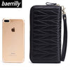 A black genuine leather travel wallet with a zipper closure next to an iPhone.