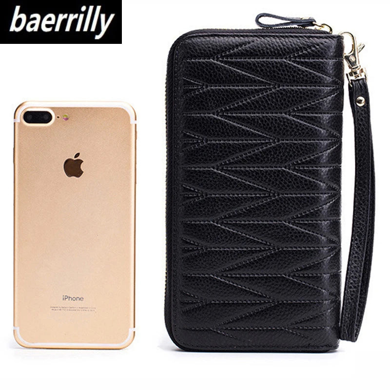 A black genuine leather travel wallet with a zipper closure next to an iPhone.