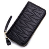 Black genuine leather RFID women's travel wallet with a zipper closure