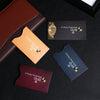 A collection of various colored RFID blocking card sleeves displayed on a dark surface.