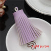 A purple leather tassel fringe craft supplies set displayed on a white plate.