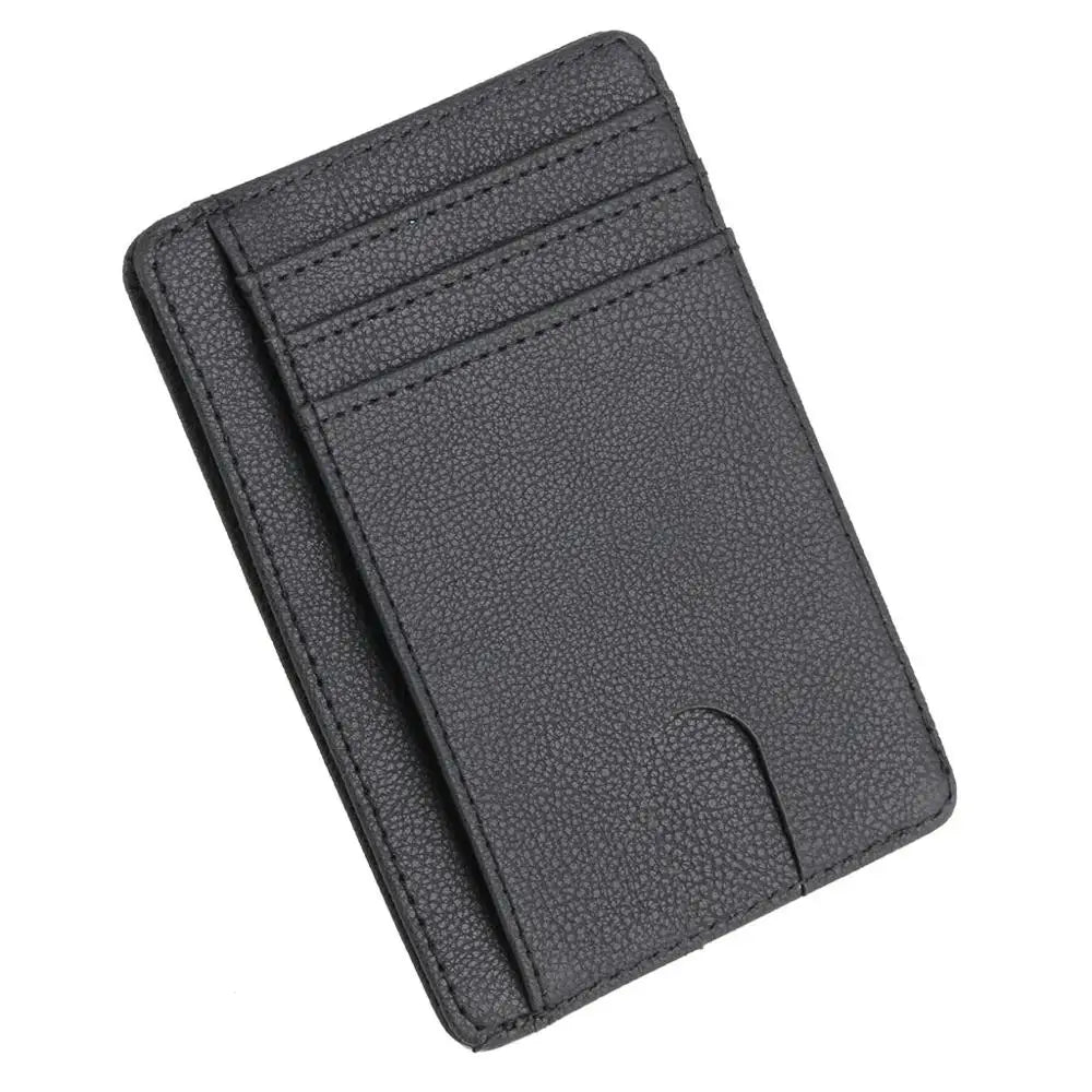 A dark gray slim leather card holder wallet with stitched edges and a flap closure.
