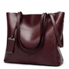 A deep burgundy waxed leather bucket bag with dual straps shown from the front.
