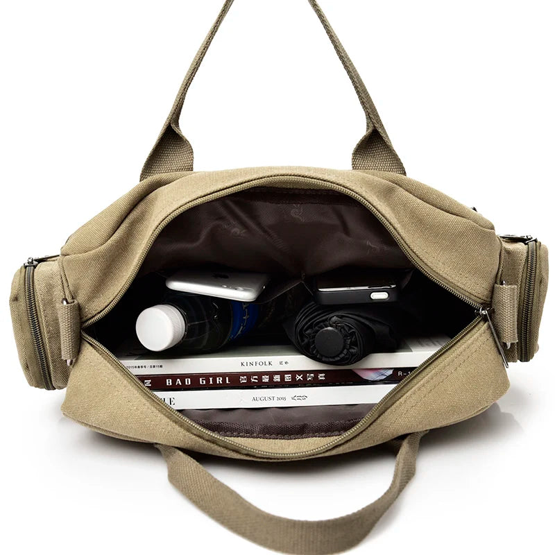 A tan canvas crossbody messenger bag with a padded interior showing a smartphone and other items.