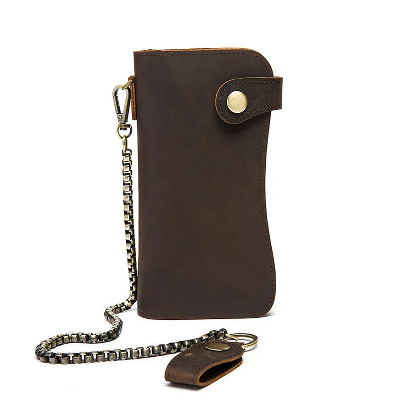 A dark brown genuine leather bifold wallet with a brass-colored metal chain attached.