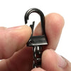 A hand holds a black metal bag chain strap with clips, showing the clasp mechanism.