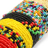Close-up of colorful belly bead chains featuring black, yellow, red, and green beads.