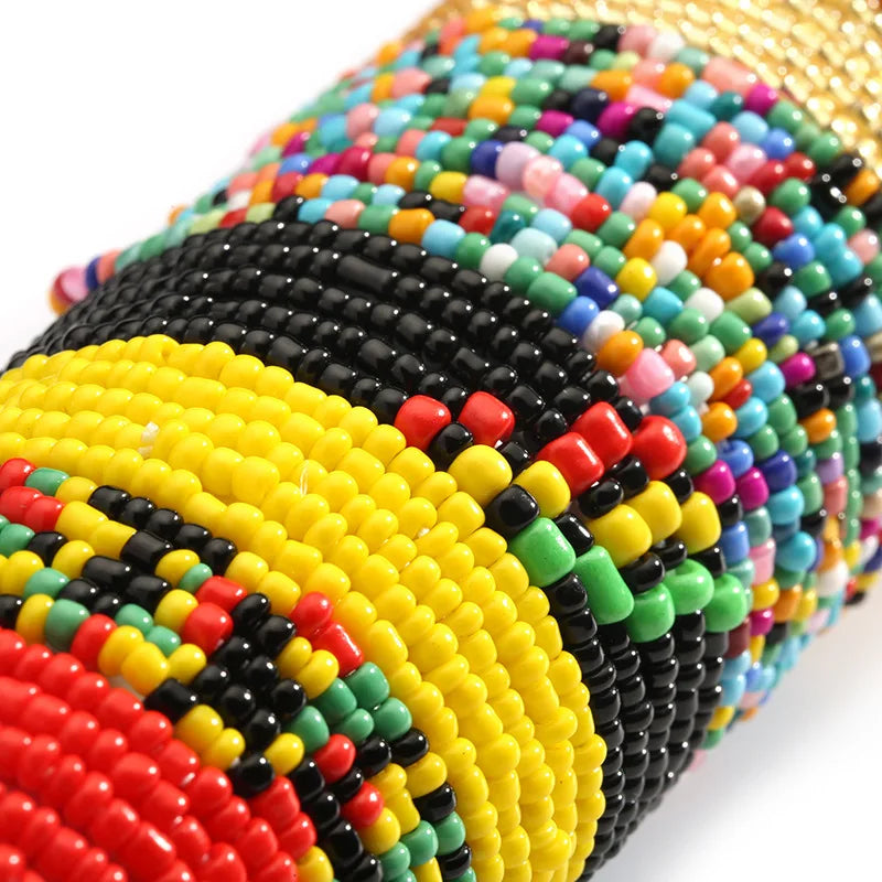 Close-up of colorful belly bead chains featuring black, yellow, red, and green beads.