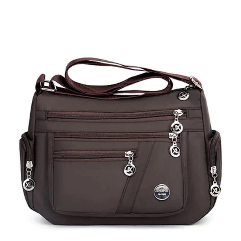 A dark brown waterproof nylon crossbody tote bag for women.