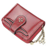 A maroon PU leather compact wallet with a flap closure and a gold-toned chain attached.