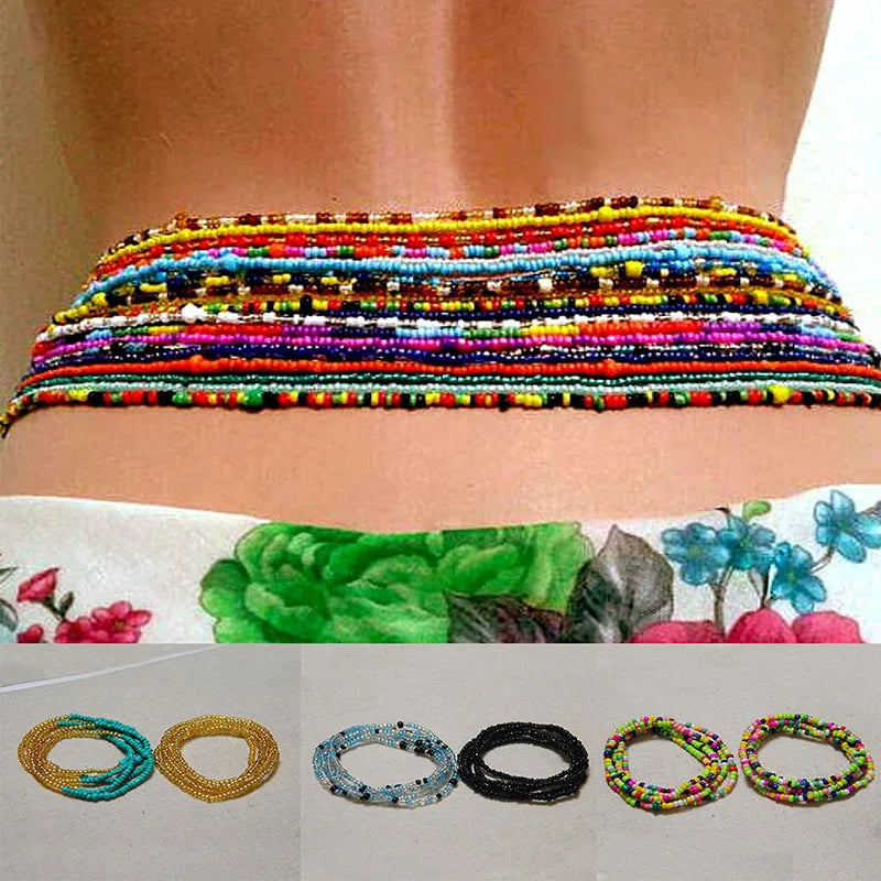 Colorful belly bead chains for body jewelry displayed on a person's abdomen.