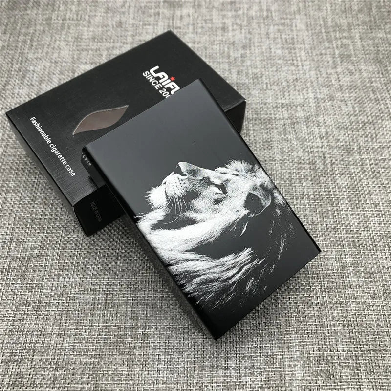 A black cigarette case with a custom engraved design of a dog's head on a gray textured background.
