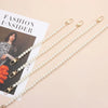 Multiple strands of pearl straps with gold clasps displayed on a light background.