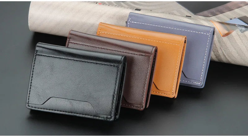 مجموعة من خمس محافظ جلد صناعي رفيعة بتقنية RFID بألوان الأسود والبني والبرتقالي والأزرق، موضوعة على قماش فاتح.