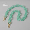 A light green adjustable detachable chain shoulder bag with a 80cm length.