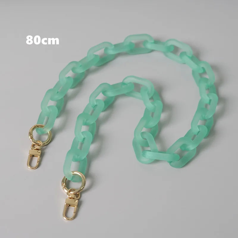 A light green adjustable detachable chain shoulder bag with a 80cm length.