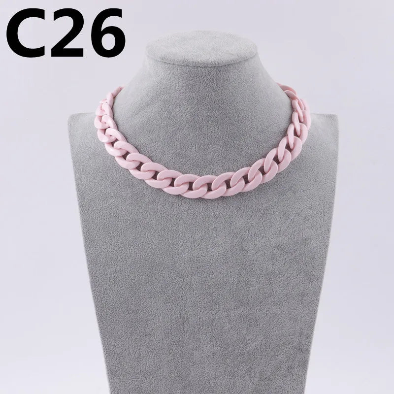 A pink acrylic link chain necklace displayed on a mannequin neck.