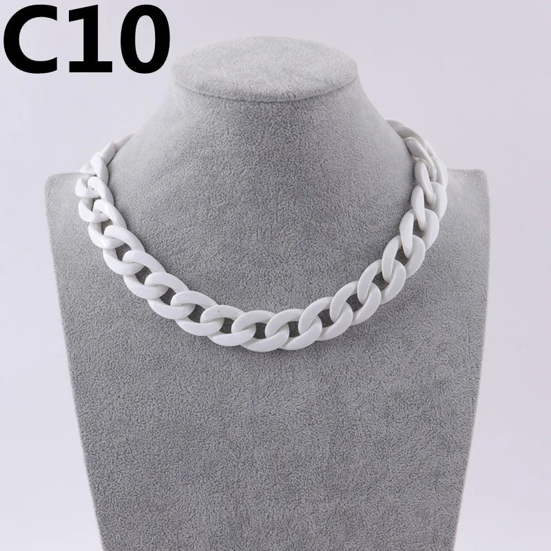 A white acrylic link chain necklace displayed on a mannequin neck.