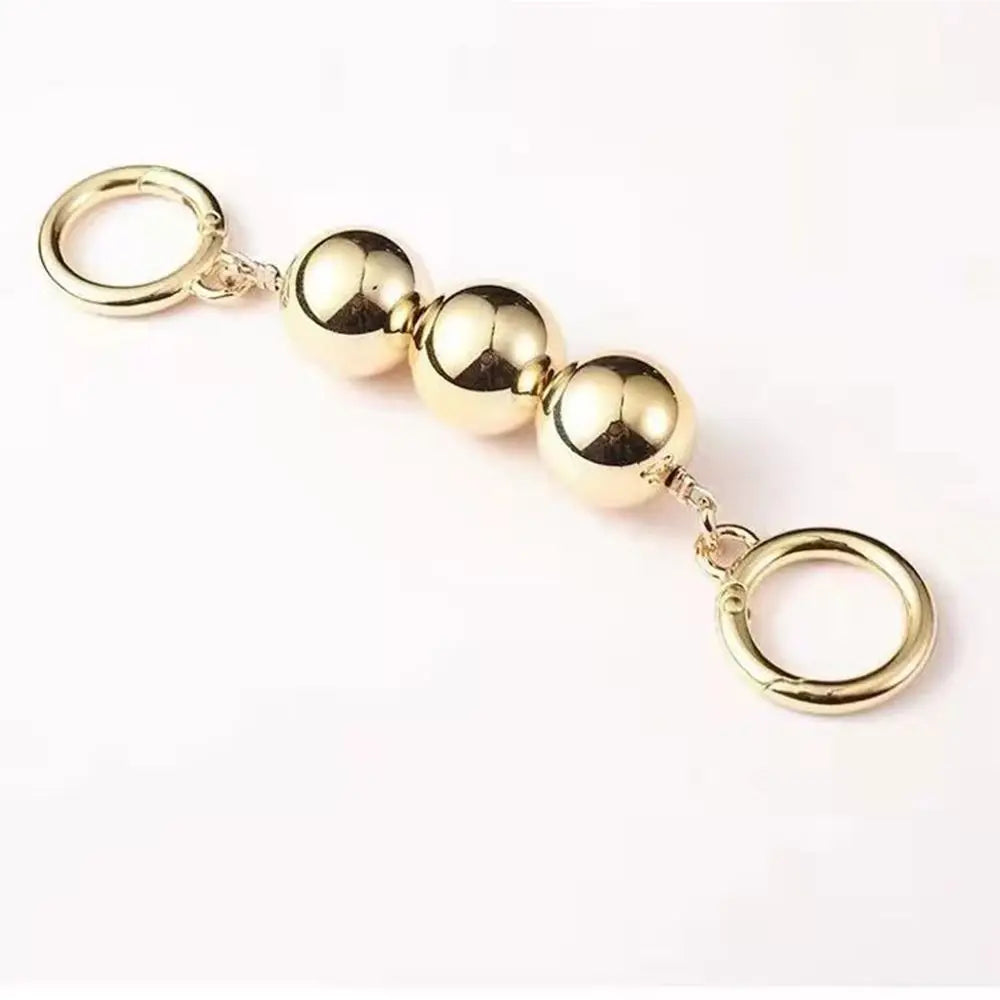Sangle de sac à perles ton or, avec un anneau circulaire et plusieurs charmons sphériques