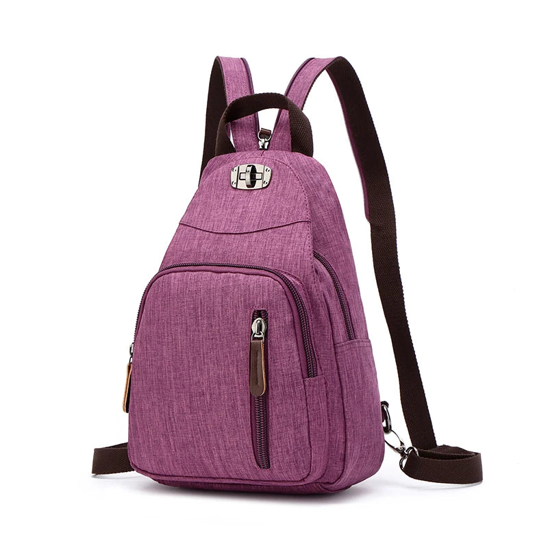 A purple canvas backpack with black straps and a silver buckle detail.