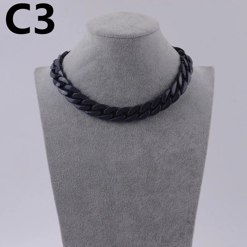 A black acrylic link chain necklace displayed on a mannequin neck.