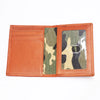 A genuine leather bifold card holder in a burnt orange color with a camouflage insert.