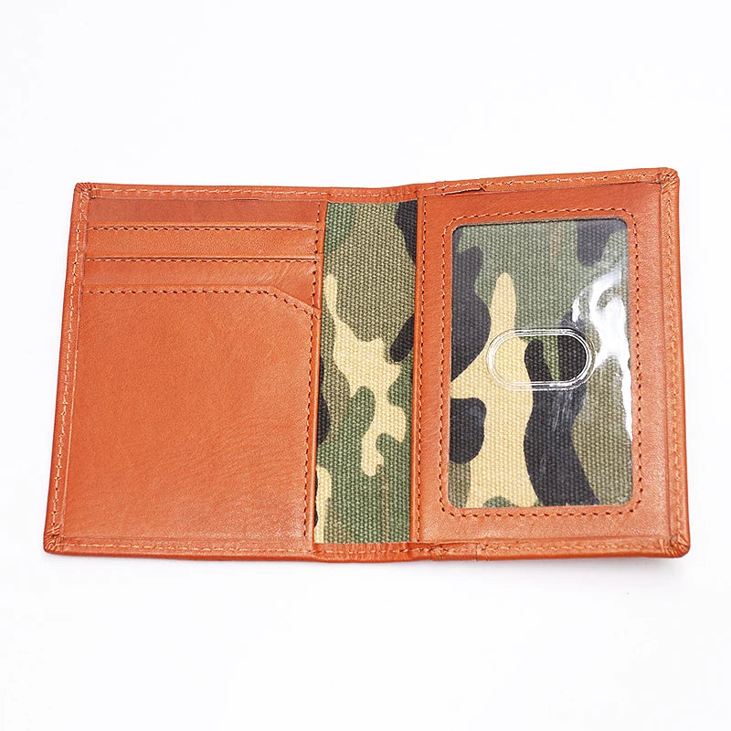 A genuine leather bifold card holder in a burnt orange color with a camouflage insert.