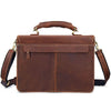 A brown vintage Crazy Horse leather briefcase with a padded handle and shoulder strap.