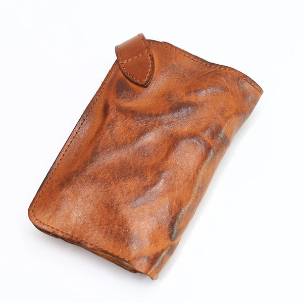 A brown vintage cowhide leather bi-fold wallet shown from above.