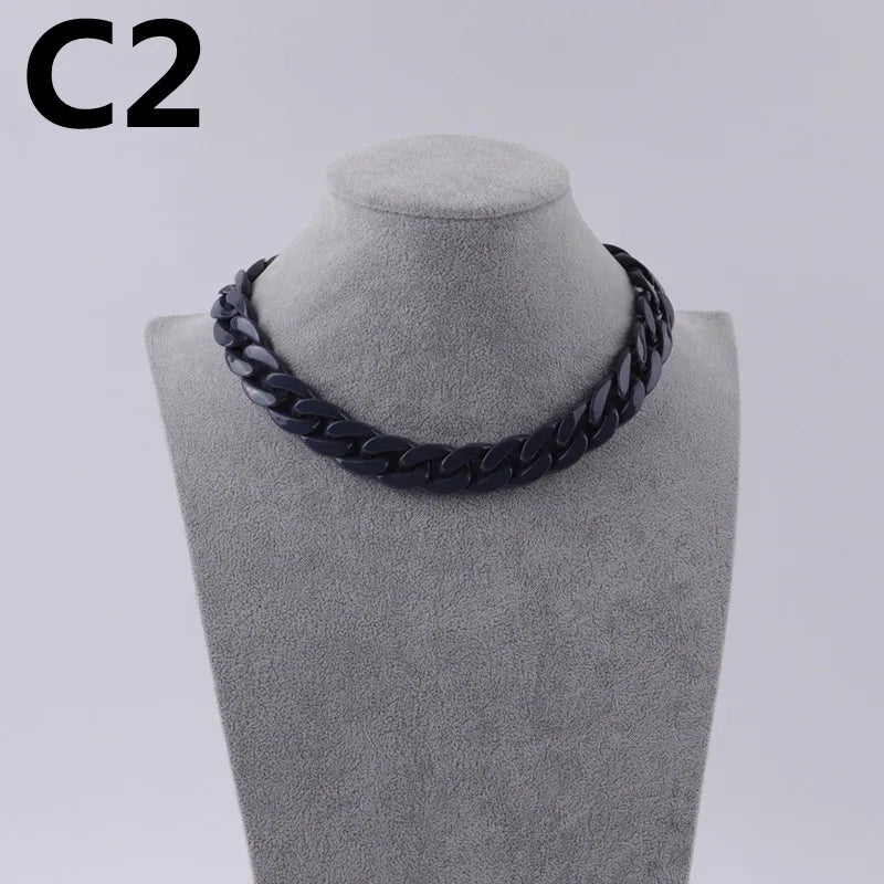 A black acrylic link chain necklace displayed on a mannequin neck.