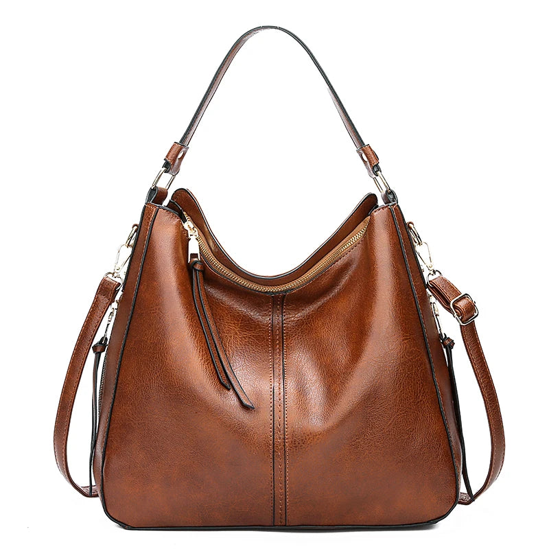 A brown vintage faux leather hobo shoulder bag with a zipper closure and leather strap.