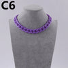 Purple acrylic link chain necklace displayed on a gray mannequin neck.