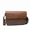 A brown retro PU leather crossbody shoulder bag for men shown against a white background.