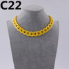 A yellow acrylic link chain necklace displayed on a gray mannequin neck.