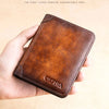 A brown leather wallet named Serphia is held in a hand against a light background.