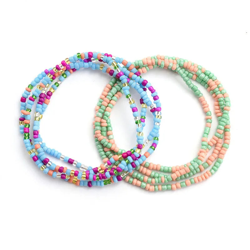 A set of colorful belly bead chains featuring pink, blue, and green beads for body jewelry.