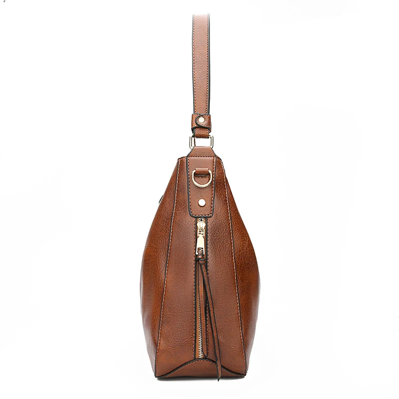 A brown vintage faux leather hobo shoulder bag with a vertical zipper and leather strap.