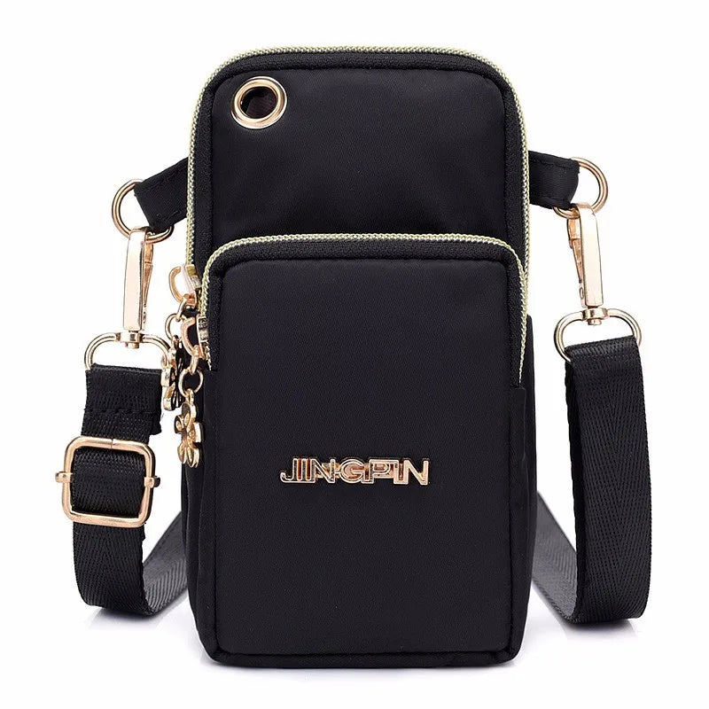 Black waterproof nylon crossbody bag with gold hardware and adjustable strap.