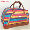 A small, striped PU leather travel duffel bag with brown handles and a pink, yellow, and blue pattern.