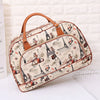 A beige PU leather travel duffel bag with brown leather handles featuring a Paris skyline design.