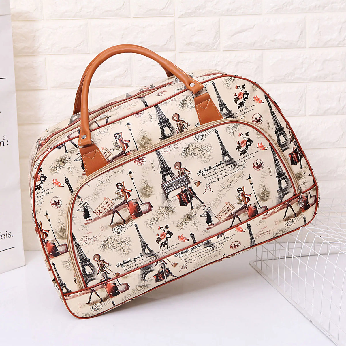 A beige PU leather travel duffel bag with brown leather handles featuring a Paris skyline design.
