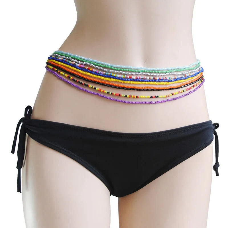 Colorful belly bead chains displayed on a mannequin torso.