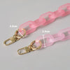 A pink adjustable detachable chain shoulder bag with gold-toned hardware and pink cord.