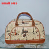 A small beige and brown PU leather travel duffel bag with a leather handle resting on a glass surface.