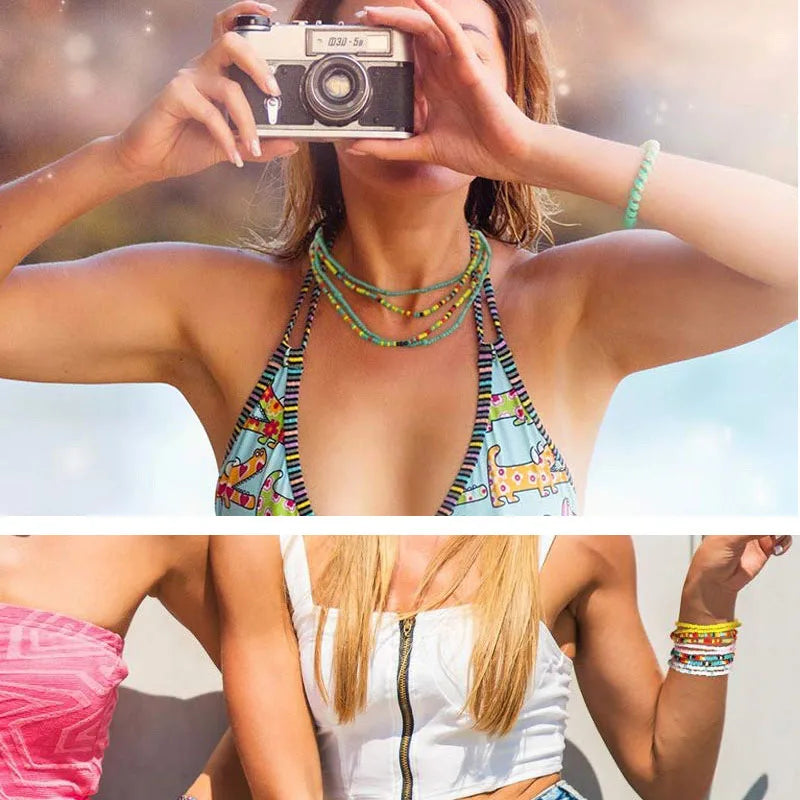 A woman models colorful belly bead chains for body jewelry against a bright outdoor background.