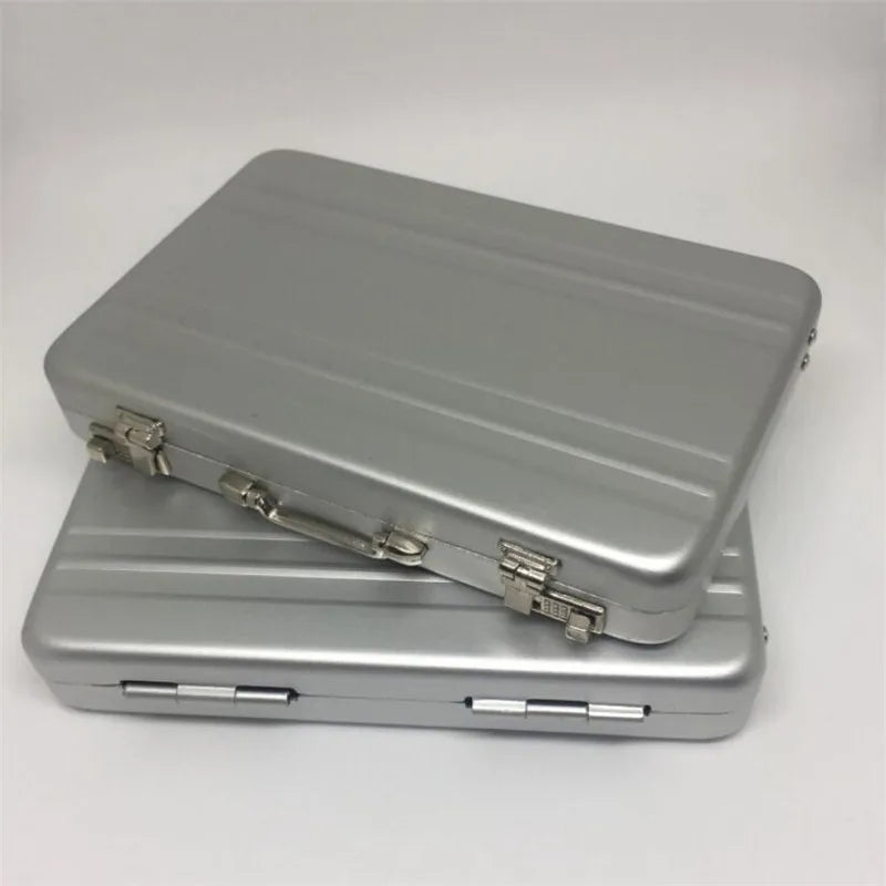 A silver aluminum credit card and ID holder case with a hinged lid resting on a flat base.