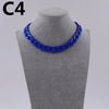 A close-up of a royal blue acrylic link chain necklace displayed on a mannequin neck.