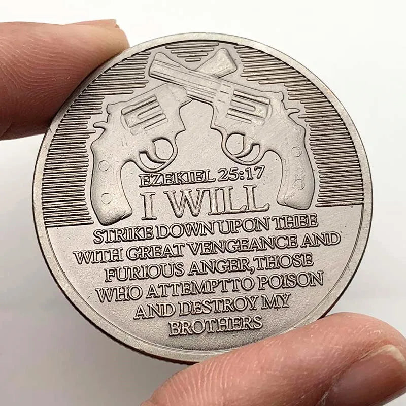 An antique silver plated commemorative coin featuring a depiction of two pistols and a biblical verse.
