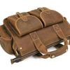 A brown genuine cowhide leather briefcase with padded compartments and leather straps.