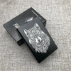 A black custom engraved cigarette case featuring a detailed wolf head design on a dark background.